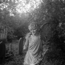 Statue of a child angel with a missing arm, Highgate Cemetery, Hampstead, London, 1987. Artist: John Gay.
