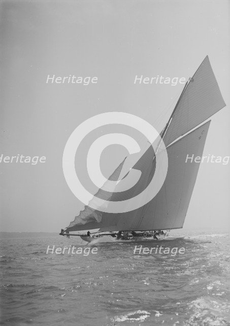 The 19-metre cutter 'Norada' sailing close-hauled, jib flapping, 1911. Creator: Kirk & Sons of Cowes.