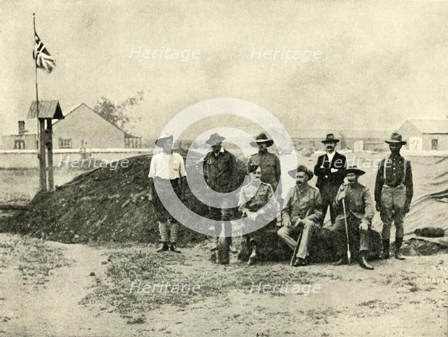 'General Baden-Powell, Lord Edward Cecil, and Other Officers, at the Entrance to their "Dug-Out".',  Creator: D Taylor.
