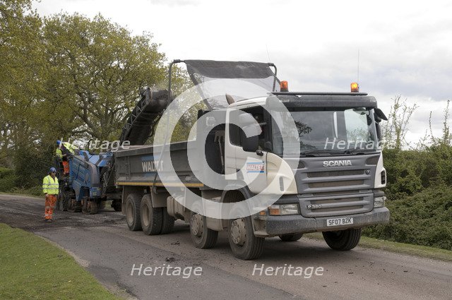 Road resurfacing work repairing potholes Artist: Unknown.