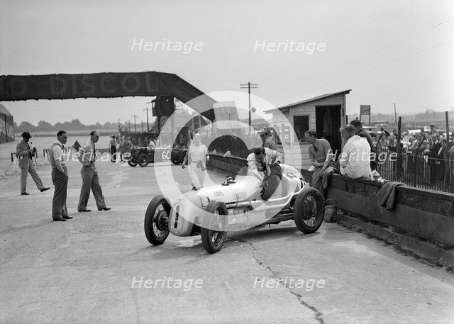 Kay Petre in an Austin 7 works team racing car, Brooklands, 1937. Artist: Bill Brunell.