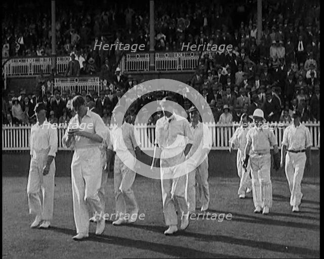 The English Cricket Team Coming Out to Play in Ashes Test in Front of a Large Crowd, 1929. Creator: British Pathe Ltd.