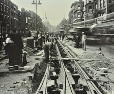 Men laying tramlines in the middle of the road, Whitechapel High Street, London, 1929. Artist: Unknown.