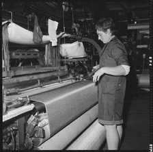 Weaver preparing a shuttle for use in a power loom, 1966-1974. Creator: Eileen Deste.