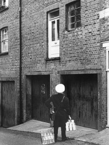 Confused milkman confronted with a doorstep on the first floor, c1955. Creator: Arthur Charles Kirby Ware.