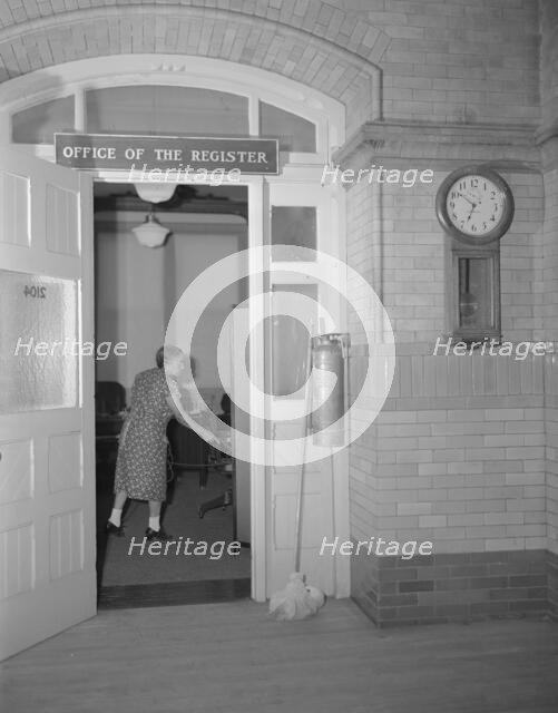 Charwoman cleaning after regular working hours at the Office...Treasury, Washington, D.C., 1942. Creator: Gordon Parks.