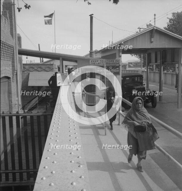 Crossing the international bridge between Juarez, Mexico and El Paso, Texas, 1937. Creator: Dorothea Lange.