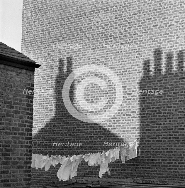 Shadows and laundry, London, 1964. Artist: John Gay