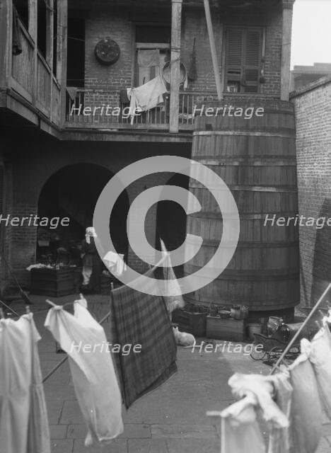 Courtyard with hanging laundry, New Orleans, between 1920 and 1926. Creator: Arnold Genthe.