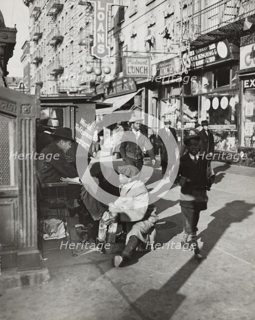 View of Lenox Avenue, Harlem, at 135th Street, showing businesses, pedestrians and..., 1939. Creator: Unknown.
