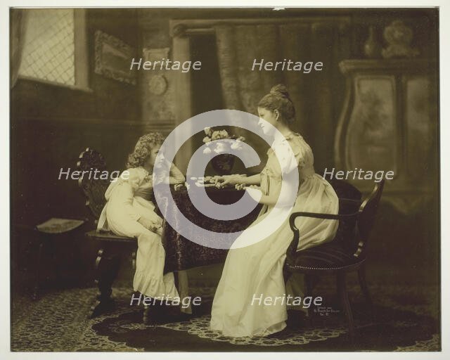 Woman and Child Playing Dominoes at Table, c. 1898. Creator: Unknown.