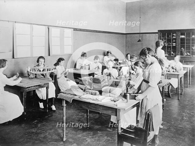 Red Cross Garment Division, Misc. Views of Work Rooms And Women Sewing, Knitting, Etc., 1917. Creator: Harris & Ewing.