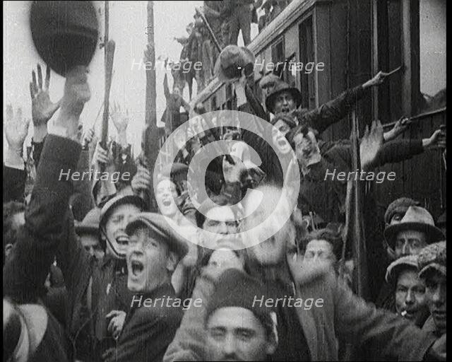 Italian Soldiers Standing on or Near a Train, Waving and Cheering, 1922. Creator: British Pathe Ltd.
