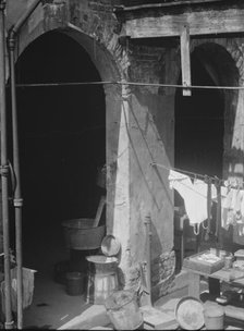 Courtyard with hanging laundry and laundry equipment, New Orleans, between 1920 and 1926. Creator: Arnold Genthe.