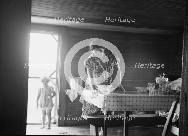 Wife of tobacco sharecropper in kitchen of home, Person County, North Carolina, 1939. Creator: Dorothea Lange.