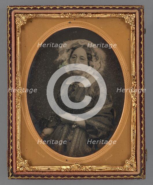 Portrait of a middle-aged woman wearing wire-rimmed glasses in flower embellished veil, 1855-1860. Creator: James McClees.