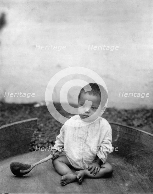 Asian(?) baby seated holding spoon or ladle, World's Columbian Exposition, Chicago, Ill., 1891 or 92 Creator: Frances Benjamin Johnston.