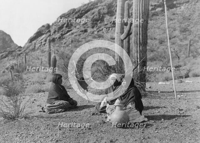 Qahatika women resting in Harvest Field-Qahatika, c1907. Creator: Edward Sheriff Curtis.