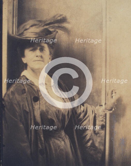 Gertrude Ka¨sebier, wearing feathered hat, standing, facing front, half-length portrait, c1900. Creator: Adolph de Meyer.
