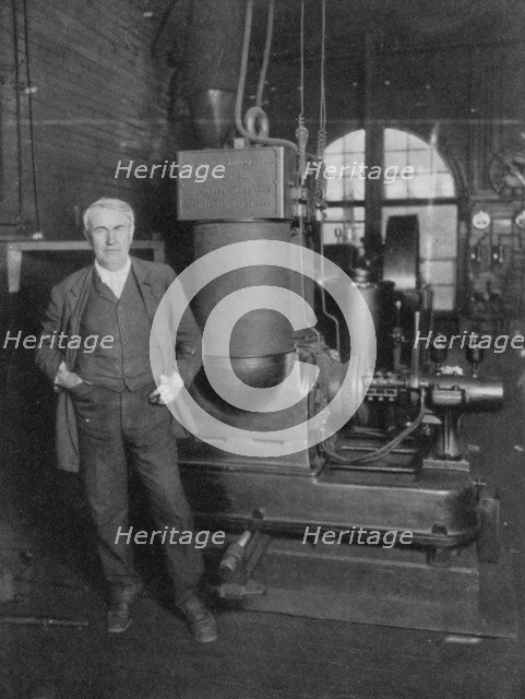 Thomas Alva Edison, American inventor, with his first dynamo for producing electric light, 1880s. Artist: Unknown