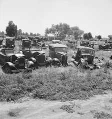 Used car lots and auto wrecking establishments, U.S. 99,  Near Tulare, California, 1939. Creator: Dorothea Lange.