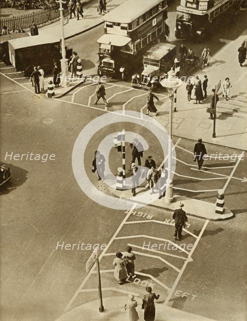 Traffic and pedestrians in Trafalgar Square, London, 1935.  Creator: Unknown.