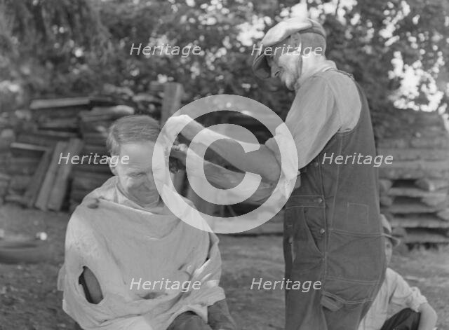 Bean pickers barbering each other, near West Staten, Marion County, Oregon, 1939. Creator: Dorothea Lange.