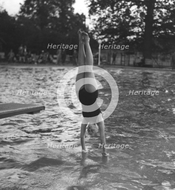 Woman diving into a swimming pool, 20th century. Artist: Unknown