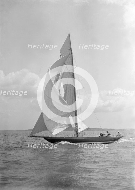 The 8 Metre 'Endrick' sailing downwind under spinnaker, 1911. Creator: Kirk & Sons of Cowes.