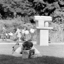 Man reading in a park, London, 1962-1964. Artist: John Gay
