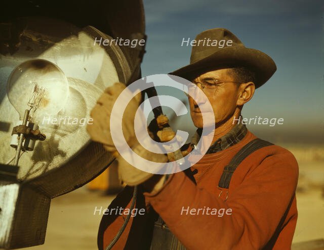 Servicing one of the floodlights that turn night into day..., Columbia Steel Co., Geneva, Utah, 1942 Creator: Andreas Feininger.