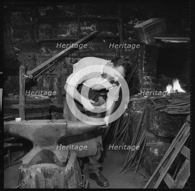 Blacksmith working at an anvil, 1967. Creator: Eileen Deste.