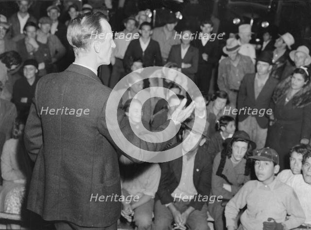 Street meeting at night in Mexican town outside of Shafter, California, 1938. Creator: Dorothea Lange.