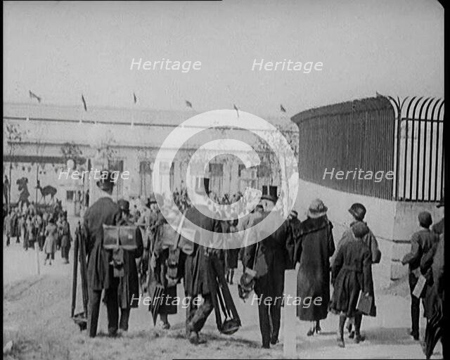 Male Newsreel Camera Operators Carrying Tripods and Equipment, 1920s. Creator: British Pathe Ltd.