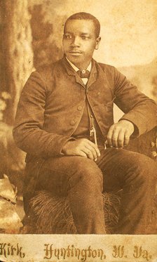 Studio portrait of unidentifed young man, seated on prop hay bale, c1870-c1879. Creator: George Wolleston Kirk.