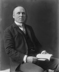 Howard Pyle, three-quarter length portrait, seated, facing slightly right, c1897. Creator: Frances Benjamin Johnston.