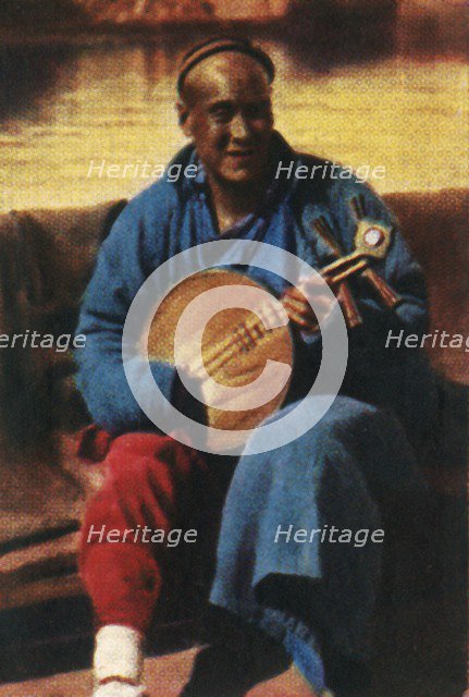 Travelling musician, China, c1928. Creator: Unknown.