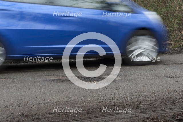 Pot holes in road surface 2017. Creator: Unknown.