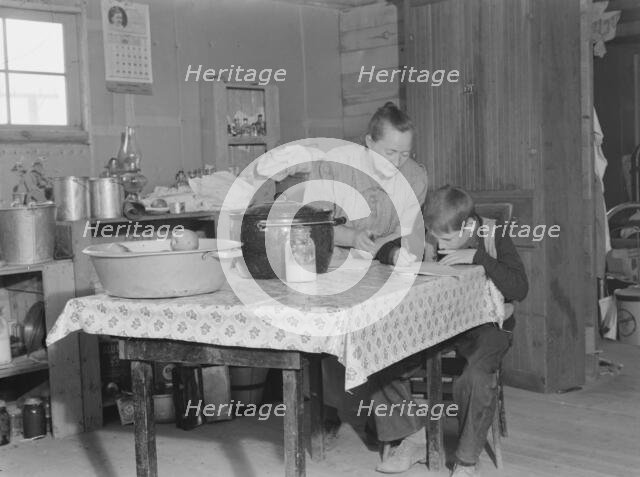 The youngest Wardlow boy copies out a recipe for his mother, Dead Ox Flat, Oregon, 1939. Creator: Dorothea Lange.