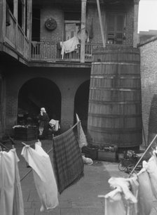 Courtyard with hanging laundry, New Orleans, between 1920 and 1926. Creator: Arnold Genthe.