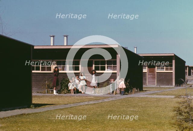 Families of migratory workers in front of their row shelters, FSA ...camp, Robstown, Tex., 1942. Creator: Arthur Rothstein.