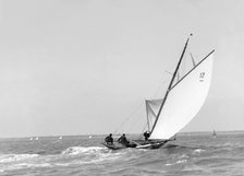 The 8 Metre sailing yacht 'Dilkusha' setting spinnaker, 1911. Creator: Kirk & Sons of Cowes.
