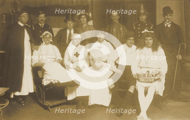 Amateur actors, some in drag, pose for a group portrait, (between 1910 and 1919?). Creator: Unknown.