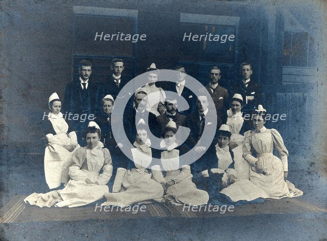 James Rutherford Morison with his staff: seven men and nine women, c1900. Creator: Unknown.