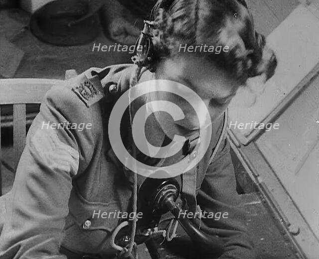 A Woman Operating a Radio, 1940. Creator: British Pathe Ltd.