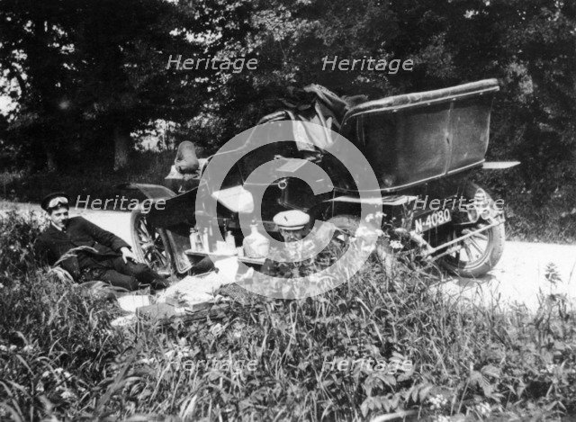 Two men picnicking beside a Vauxhall car, c1906. Artist: Unknown