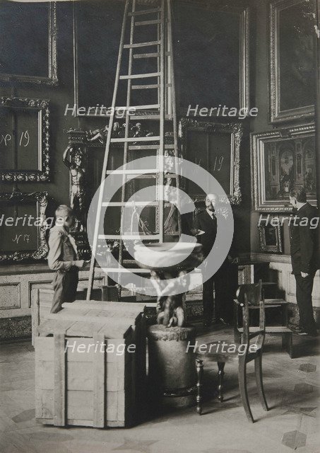 Preparing paintings for evacuation from one of the Italian halls at the Hermitage, 1917.