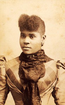 Half-portrait of young woman wearing large lace scarf over plaid bodice, c1880-c1889. Creator: James O Durgan.