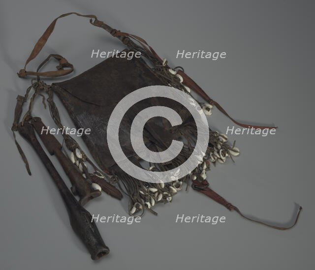 Leather bag with tools, whistles, and shells, 20th Century. Creator: Unknown.