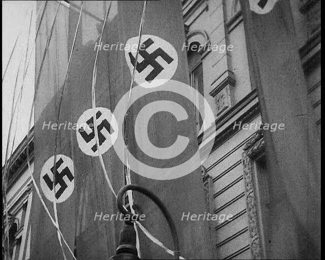 German Nazi Banner Flags Hanging from the Frontage of a Building, 1939. Creator: British Pathe Ltd.